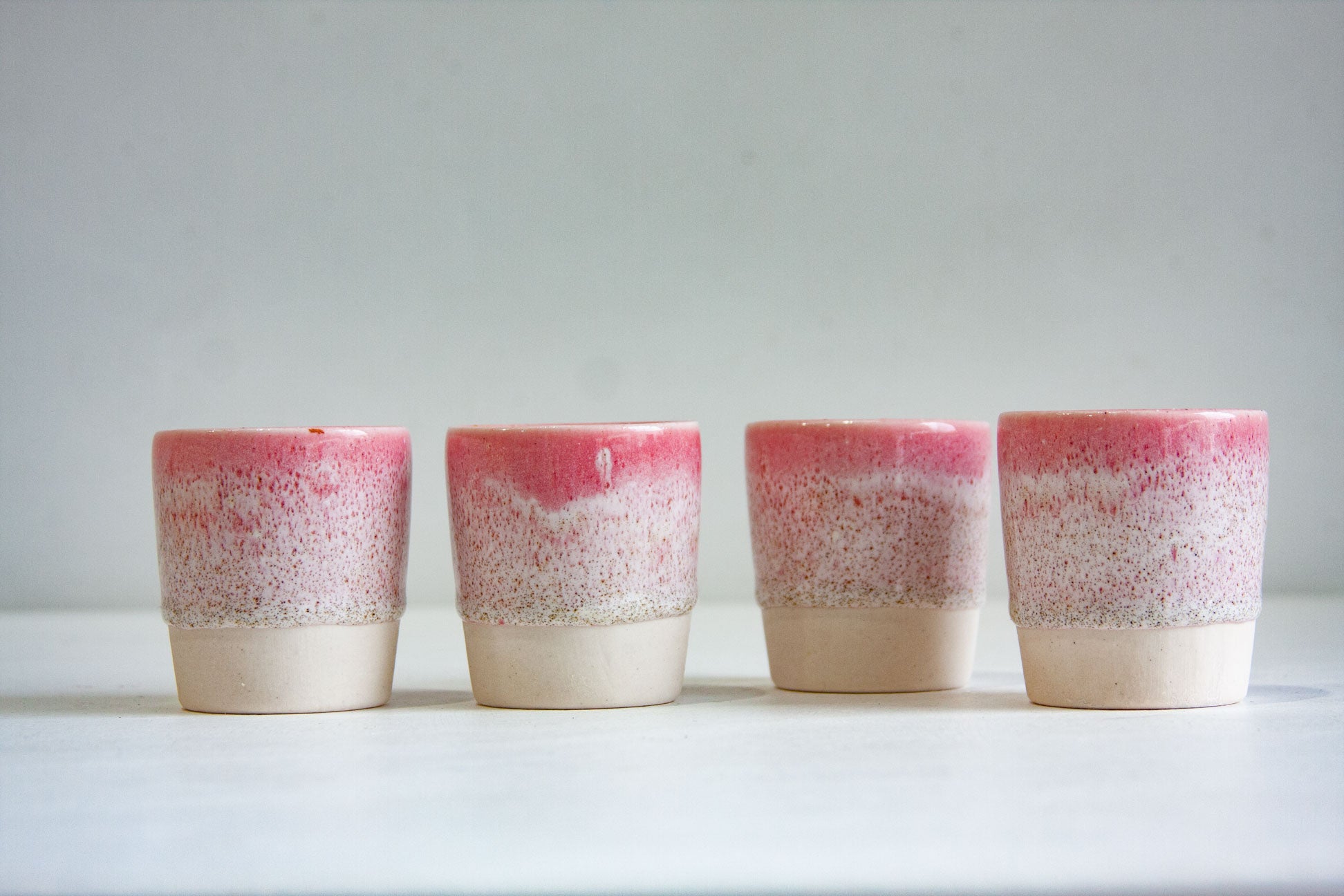 four handmade ceramic espresso cups glazed in speckled pink