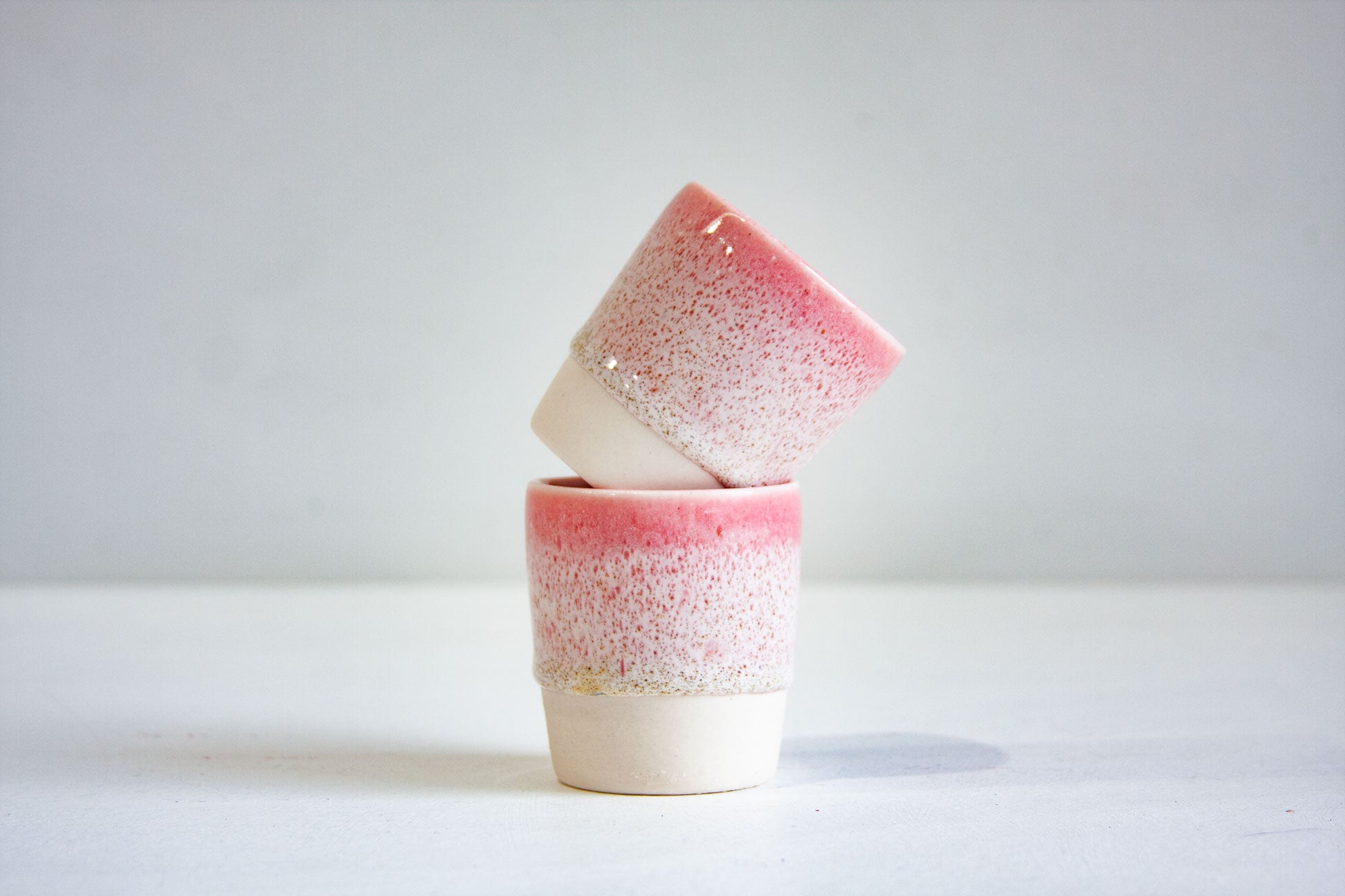 photo of two speckled pink espresso cups 