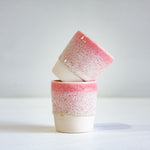 photo of two speckled pink espresso cups 