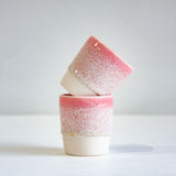 photo of two speckled pink espresso cups 