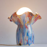 handmade ceramic table lamp shown with light on 