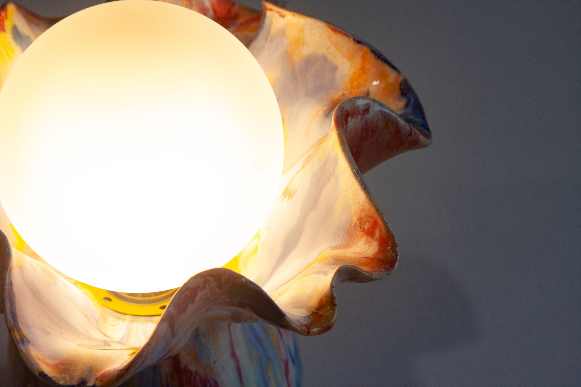 handmade ceramic table lamp shown with light on