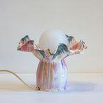 handmade ceramic table lamp glazed in a fluid drippy pink, peach and blue colour.