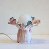 handmade ceramic table lamp glazed in a fluid drippy pink, peach and blue colour.