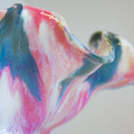 zoomed in picture of the pink, blue, peach and white glaze on ceramic table lamp
