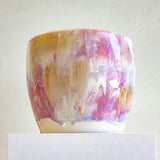 Handmade ceramic pastel pink planter shown on plinth 