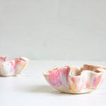 Two ceramic bowls with marbled pink and white design on a light gray background