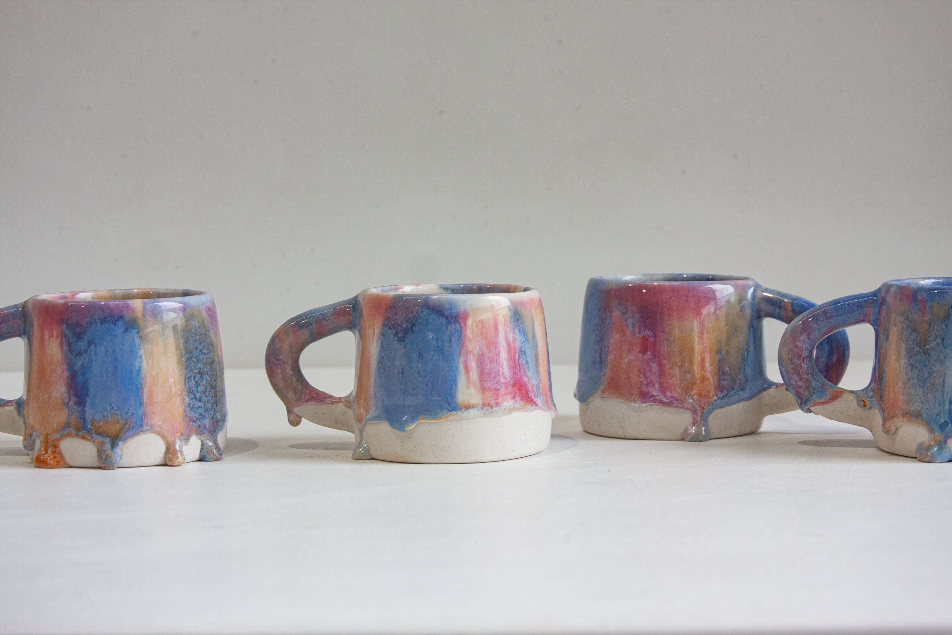four handmade ceramic pink, peach and blue mug 