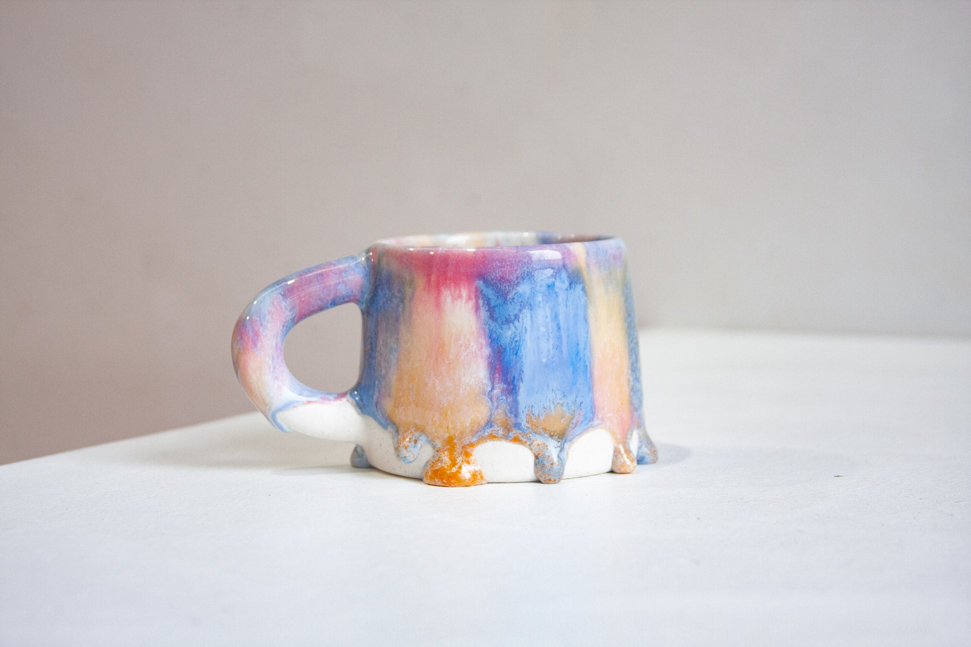 single handmade ceramic drippy glaze pink, blue and peach mug