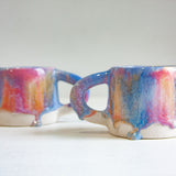photo of two handmade ceramic drippy glaze mugs