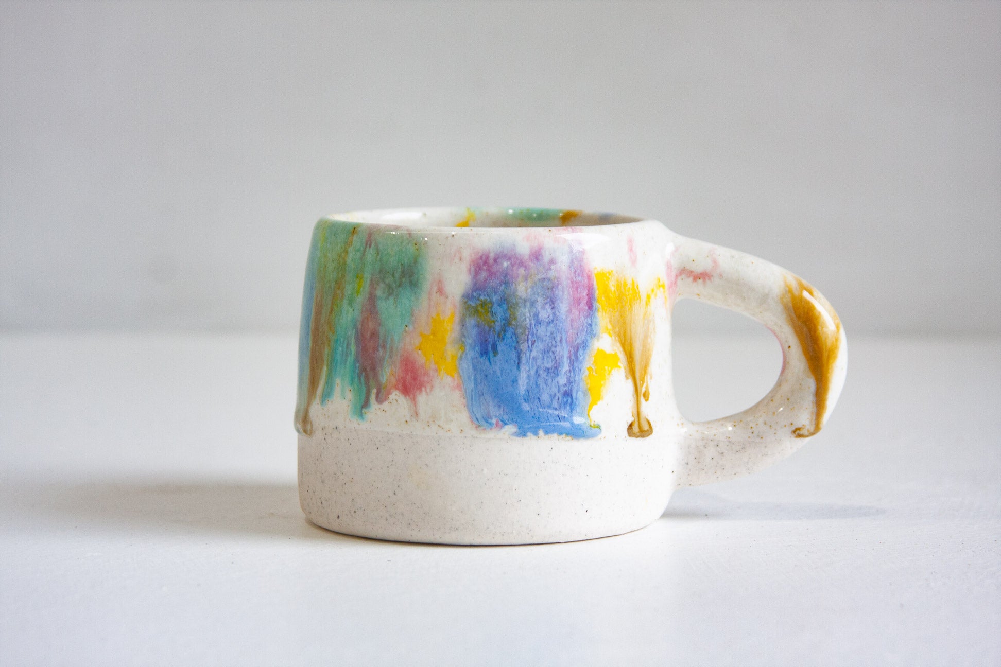 Ceramic mug with watercolour design on a white background