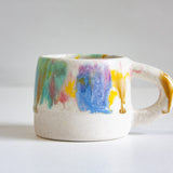 Ceramic mug with watercolour design on a white background