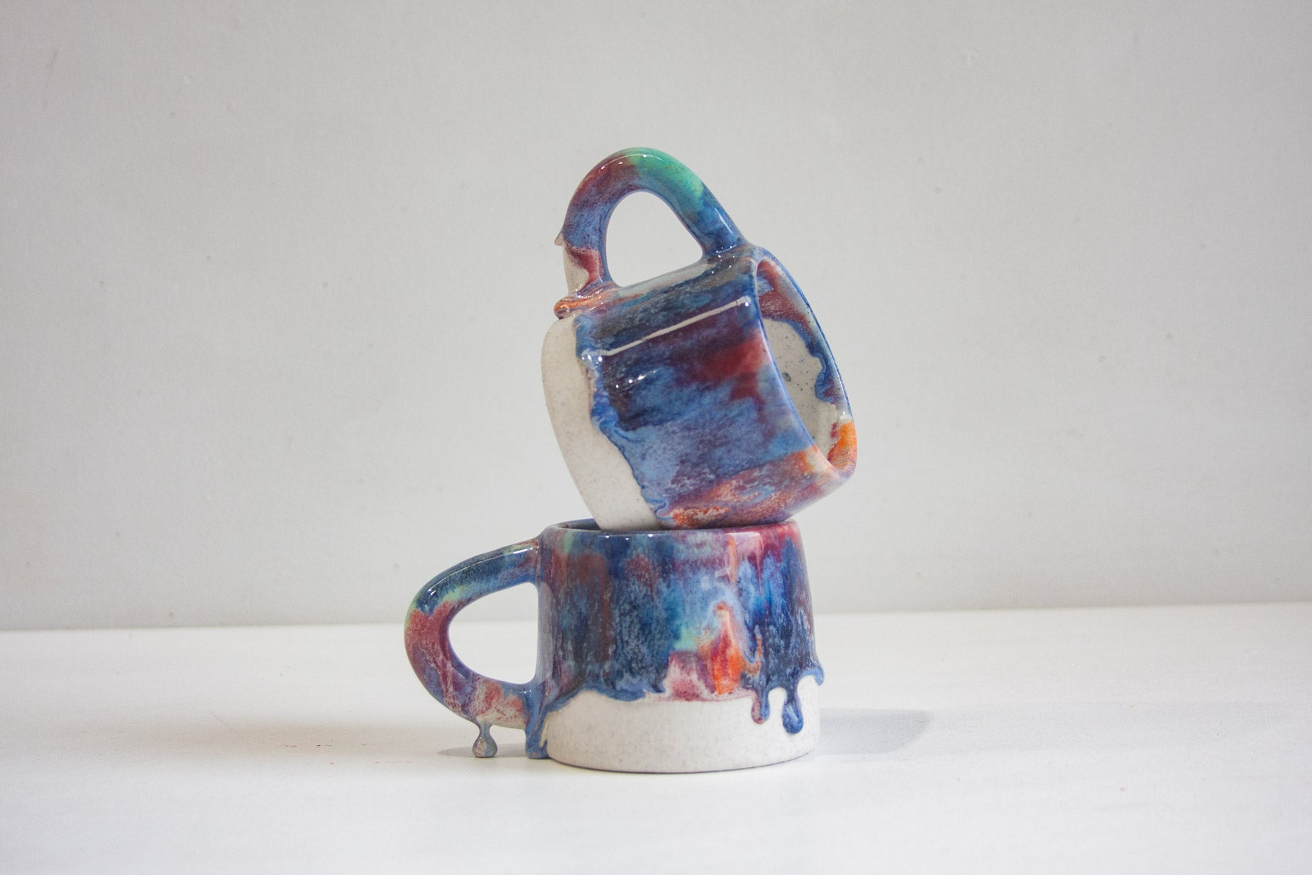 handmade ceramic mugs, one on top of each other.