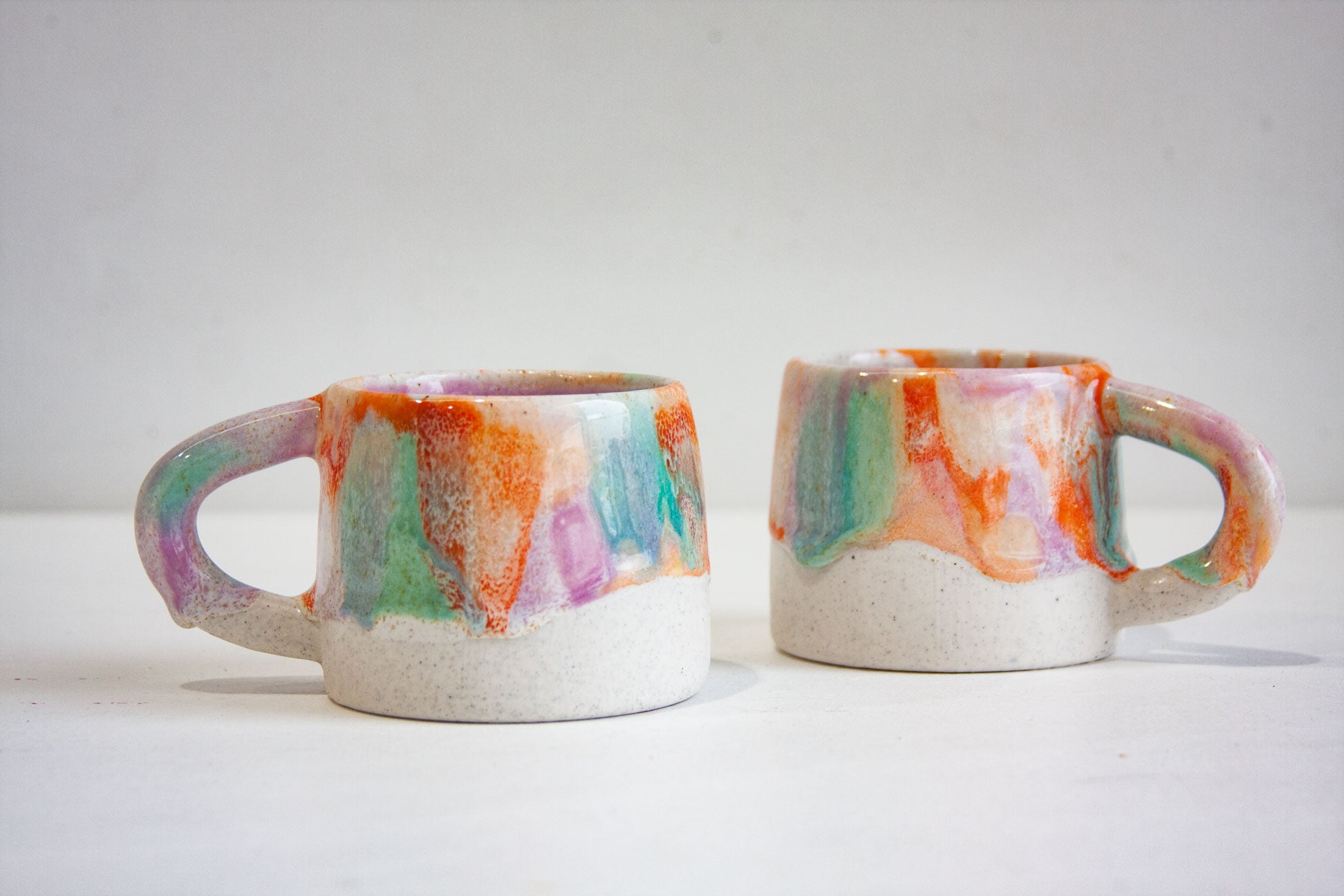 handmade ceramic orange, purple and green mug