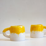 handmade yellow and white ceramic mug