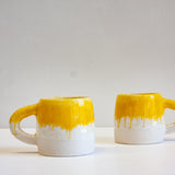handmade yellow and white ceramic mug