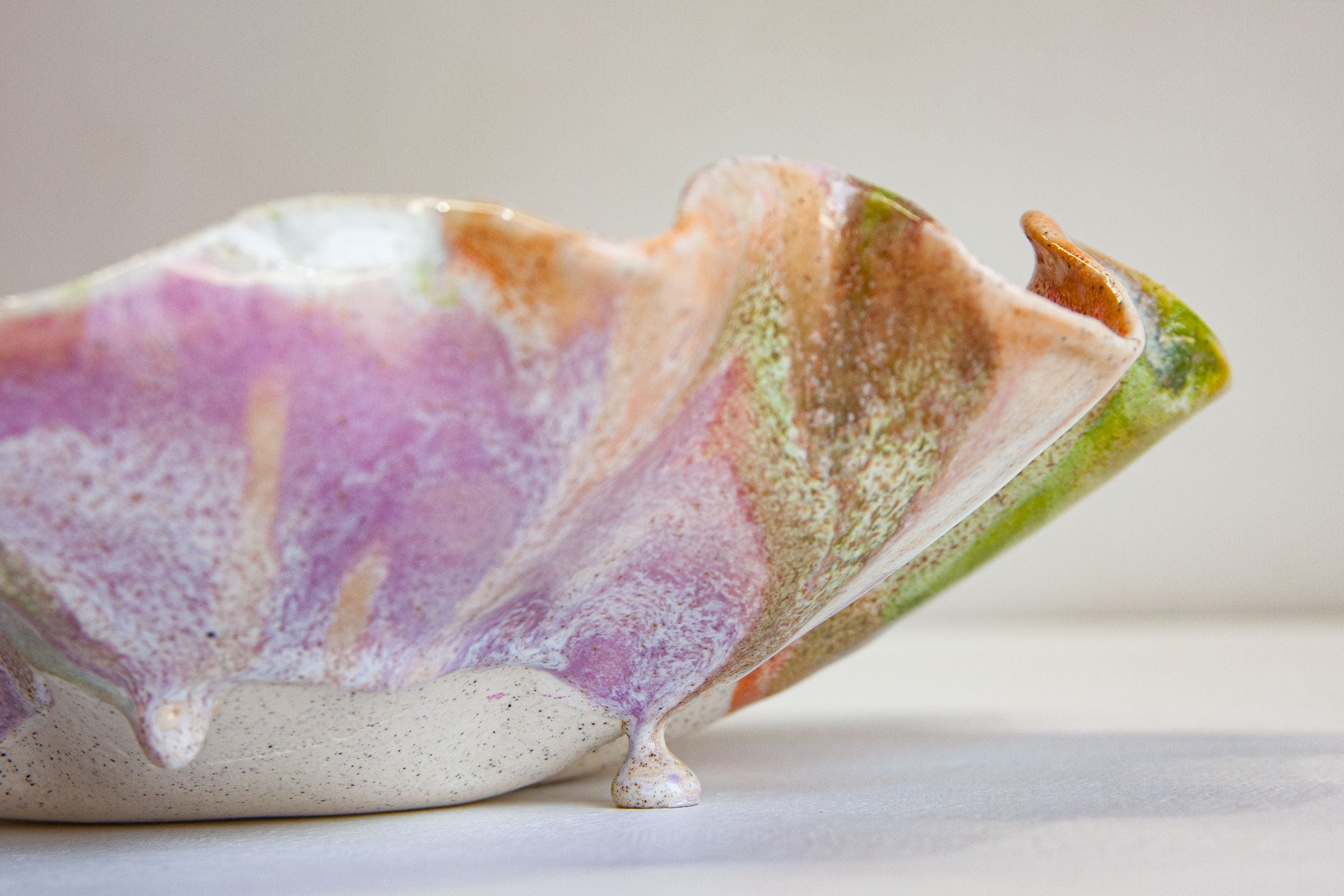 close up of glaze drip on ceramic frilly oyster bowl platter