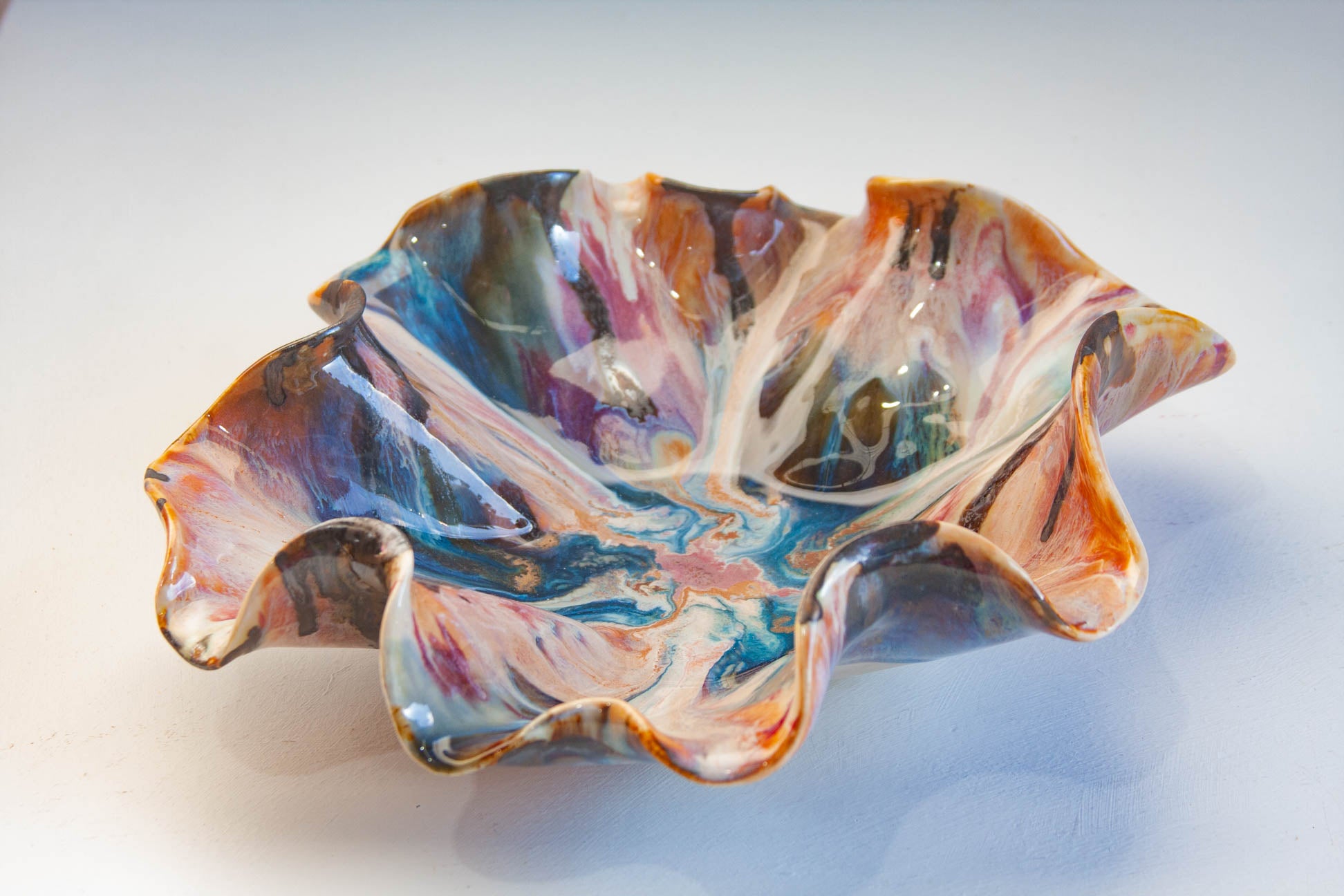 handmade ceramic platter glazed in blue, brown, peach and blue.
