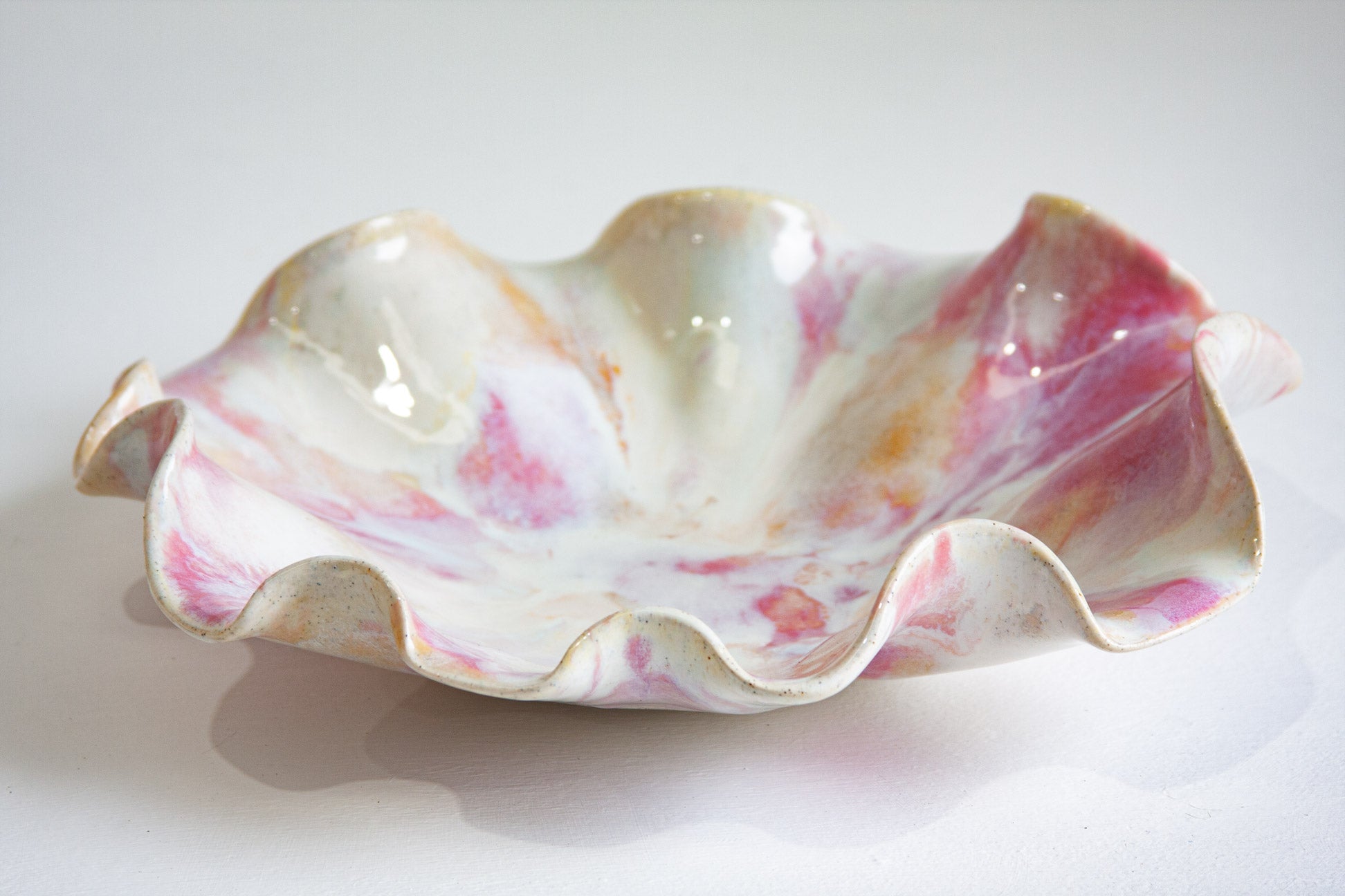 Decorative shell-shaped bowl with marbled design on a white background