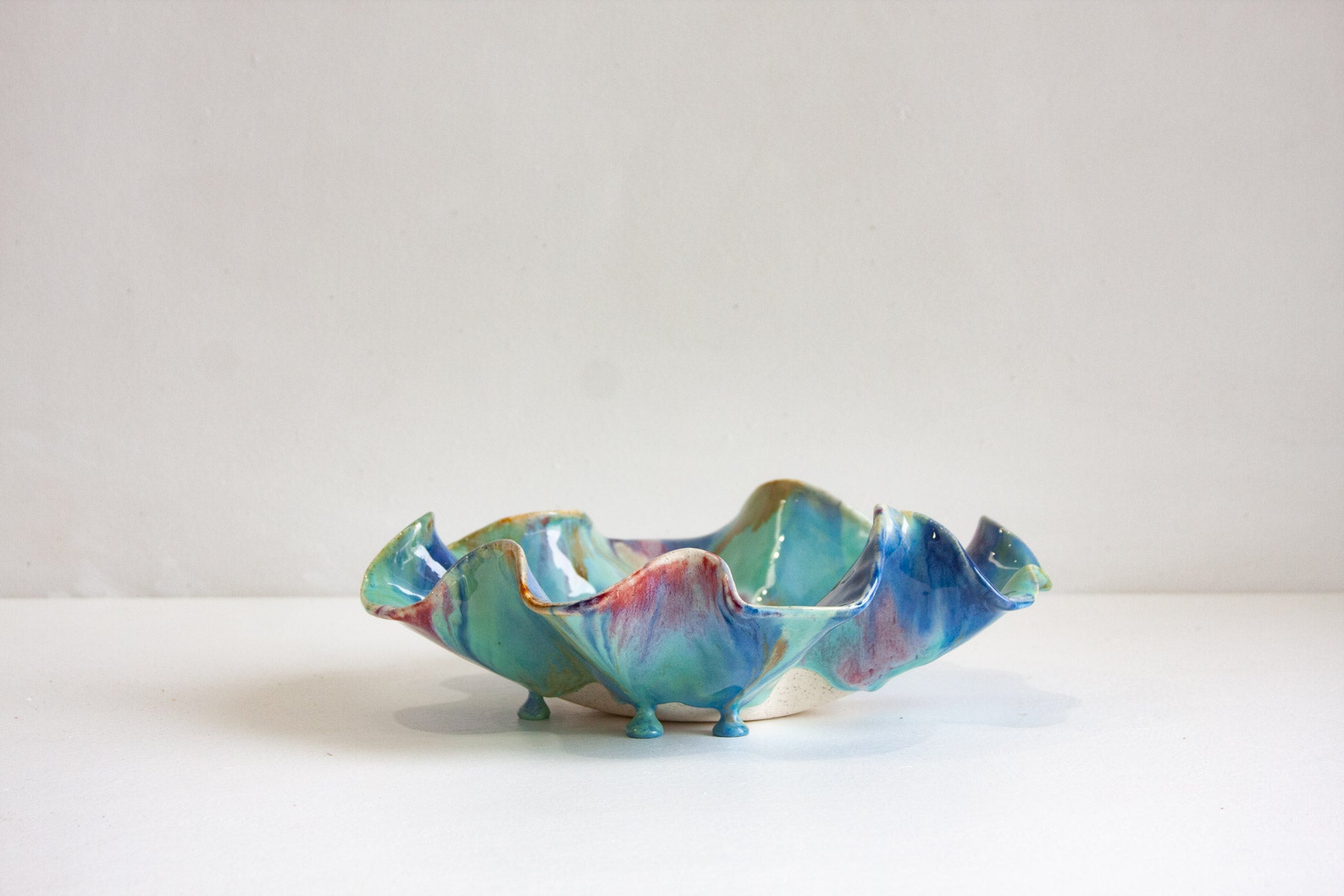 Multicoloured ceramic platter on a white background