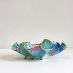 Multicoloured ceramic platter on a white background