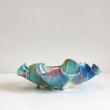 Multicoloured ceramic platter on a white background