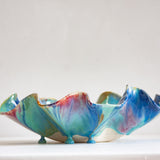 Colourful ceramic bowl with a marbled design on a white background