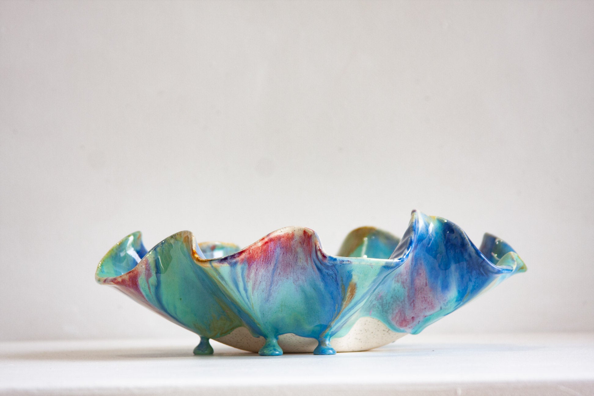 Colourful ceramic bowl with a marbled design on a white background