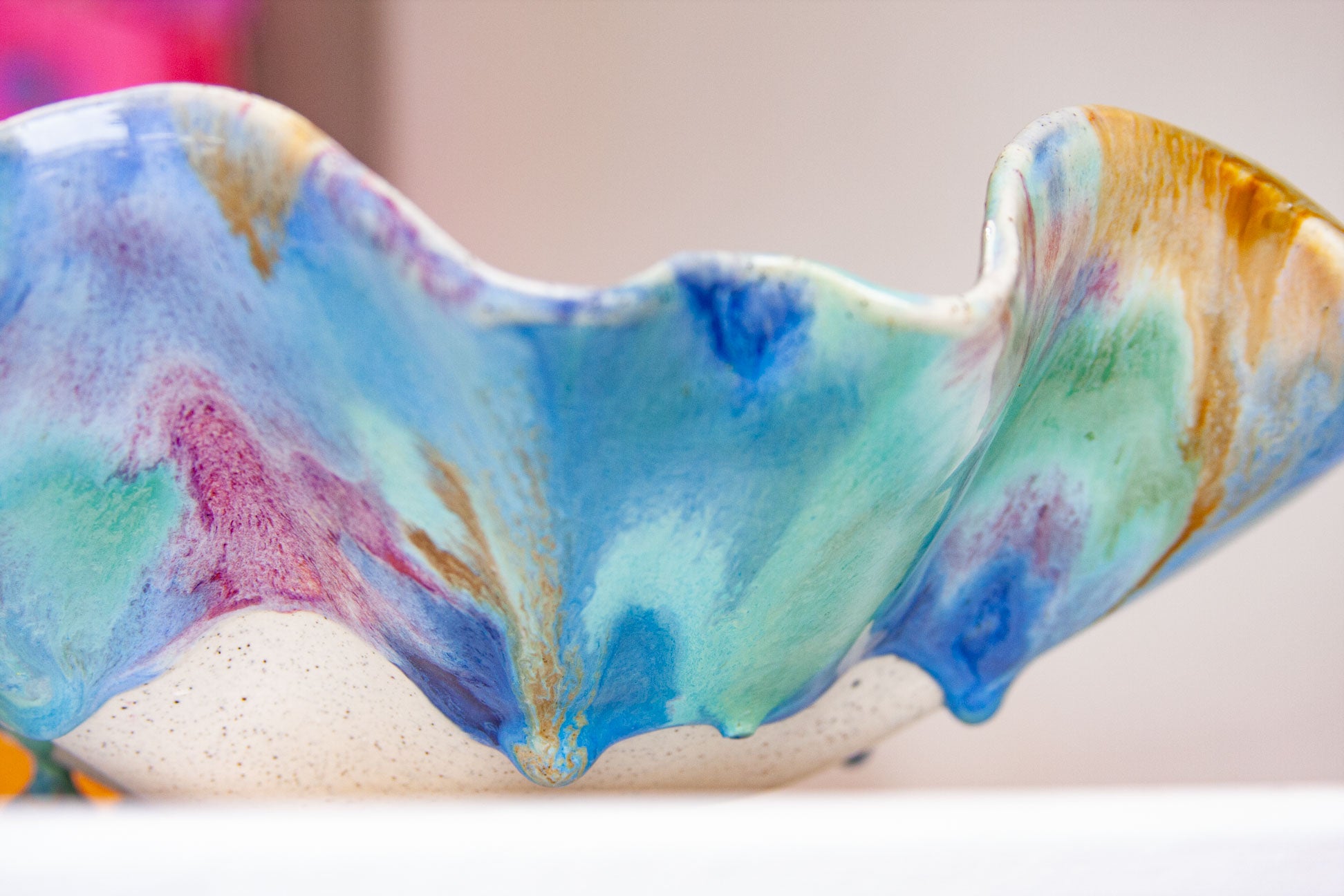 Colourful ceramic bowl with abstract patterns on a blurred background