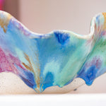 Colourful ceramic bowl with abstract patterns on a blurred background