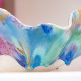 Colourful ceramic bowl with abstract patterns on a blurred background