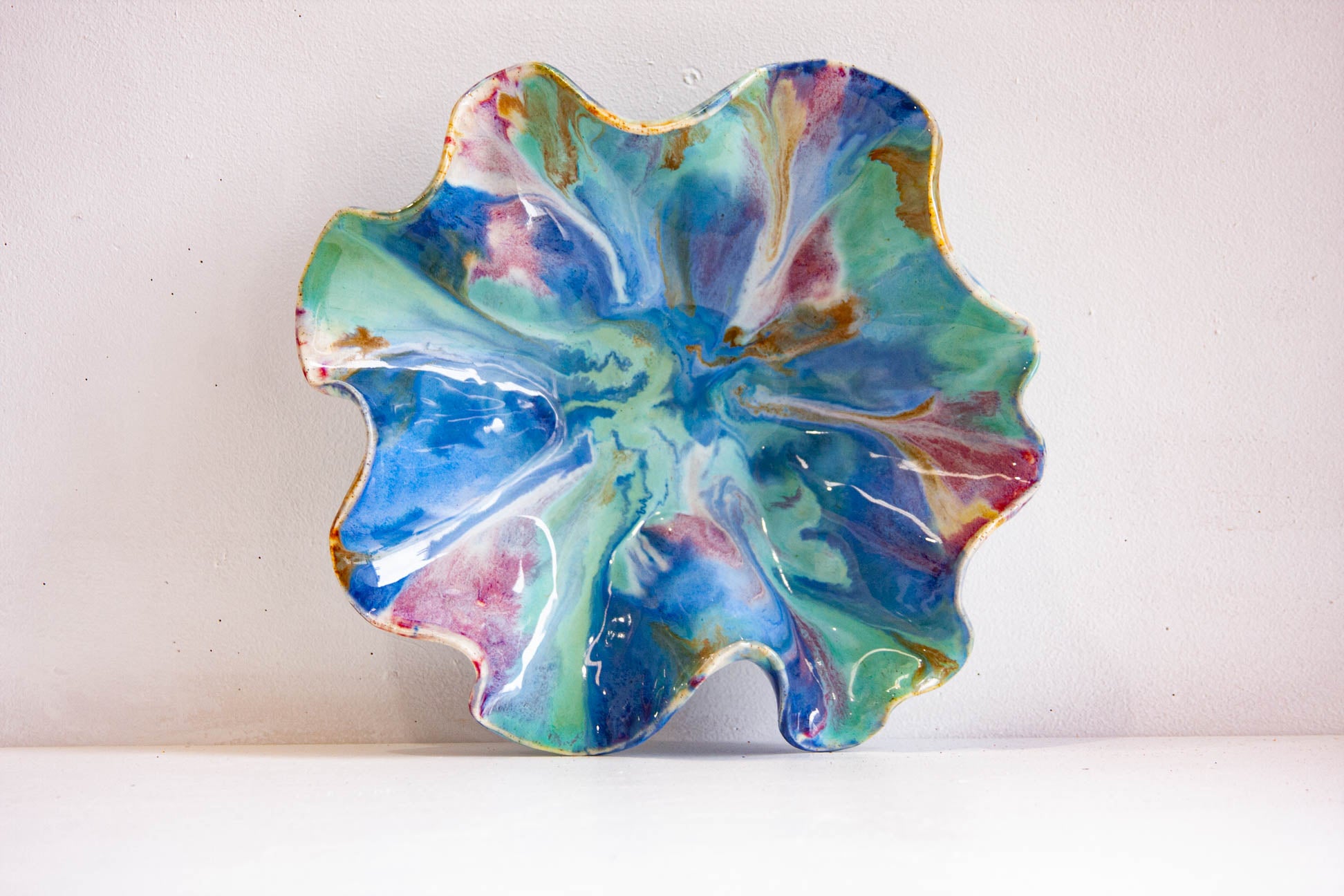 Colourful ceramic oyster plate on a white background