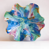 Colourful ceramic oyster plate on a white background