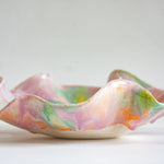 Multicoloured ceramic bowl on a white background
