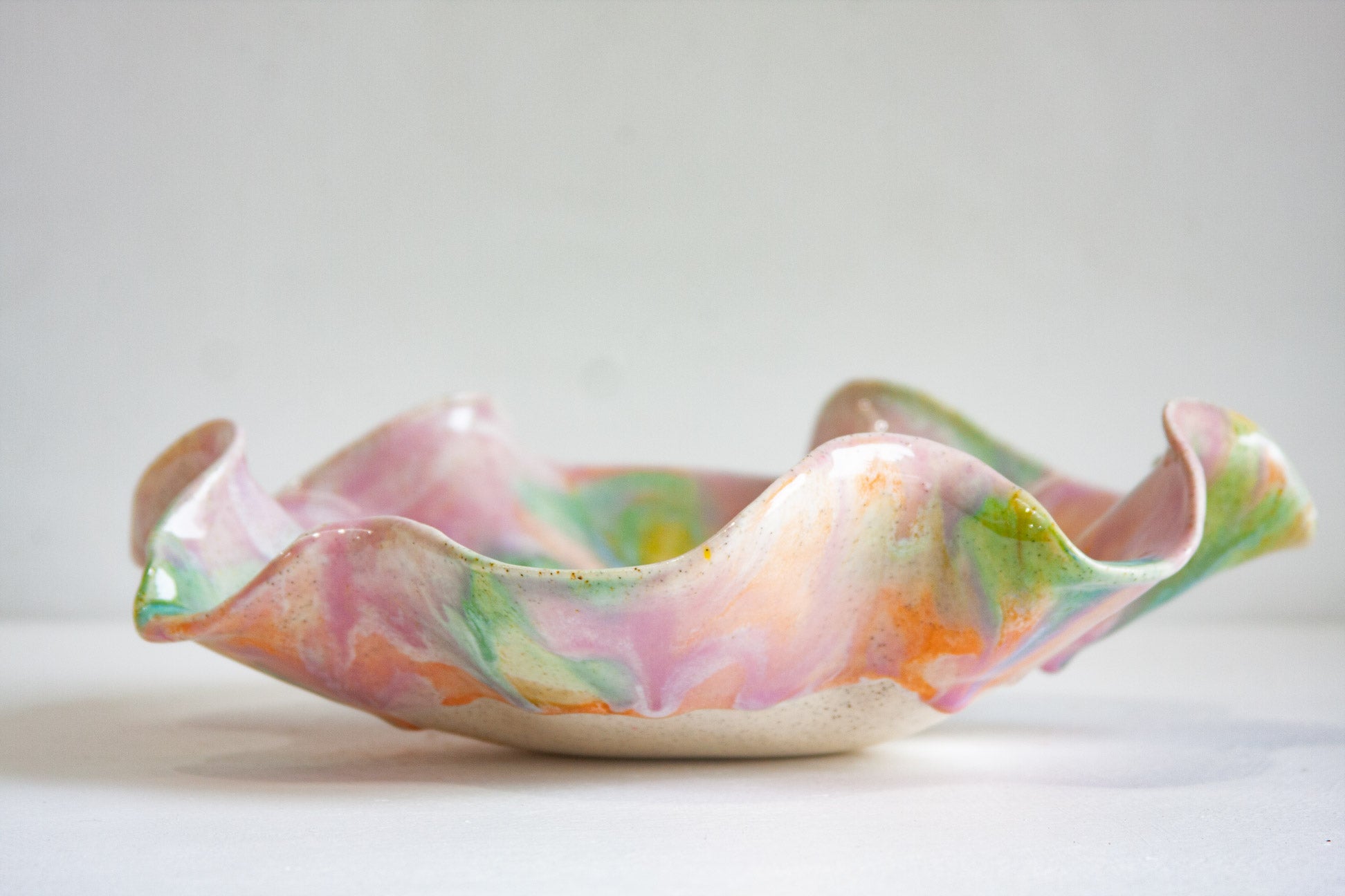 Multicoloured ceramic bowl on a white background
