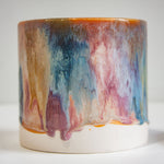 close up of pink, peach, brown and blue glazed cylindrical planter