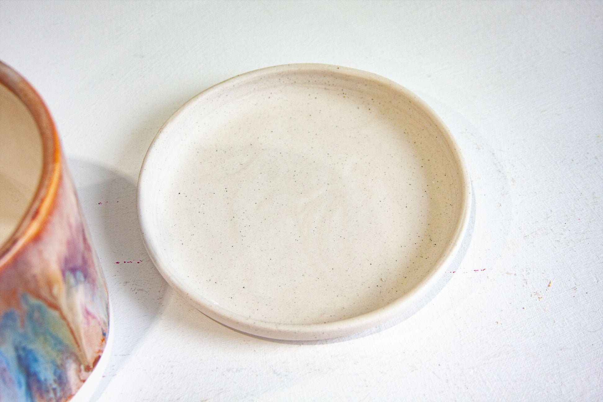photo of speckled handmade ceramic drip tray saucer