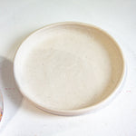 photo of speckled handmade ceramic drip tray saucer