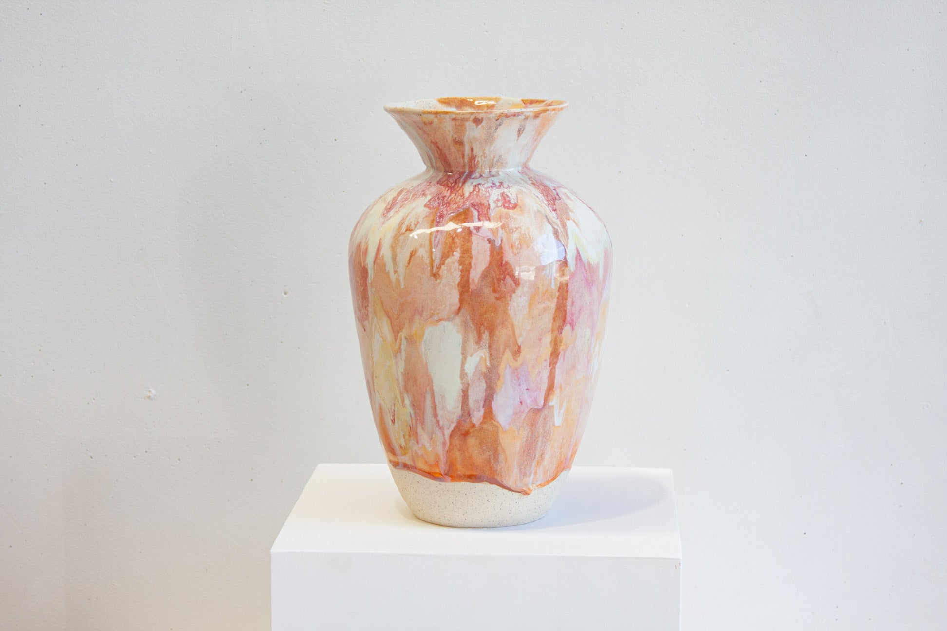 handmade ceramic large sculptural vase on a white plinth.