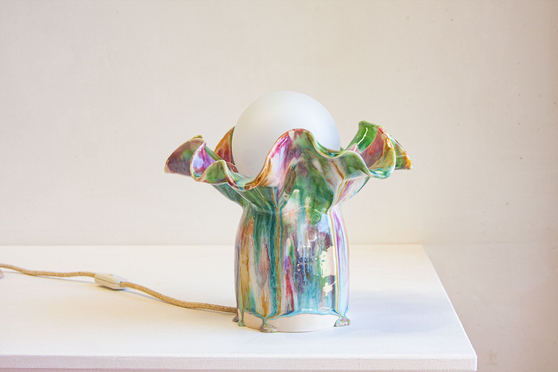 handmade ceramic table lamp shown on table