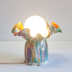 handmade ceramic lamp shown with light on 