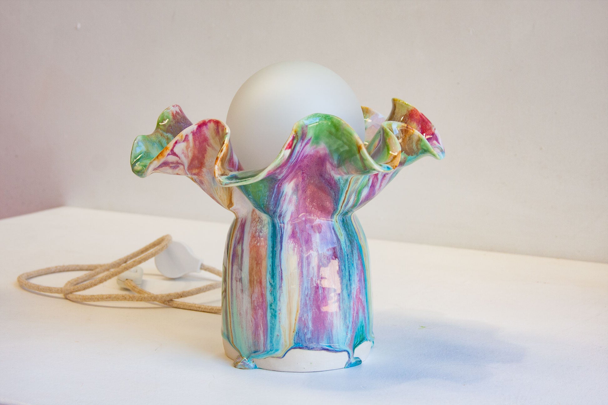 handmade ceramic table lamp glazed in pink, blue, green, peach and brown