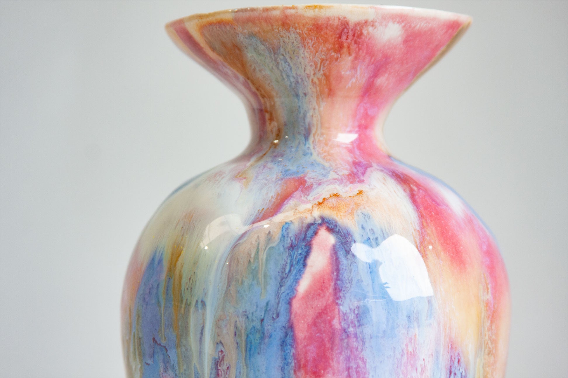 Multicolored ceramic vase on a plain background