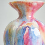 Multicolored ceramic vase on a plain background