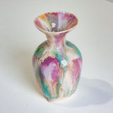 Multicolored ceramic vase on a white background