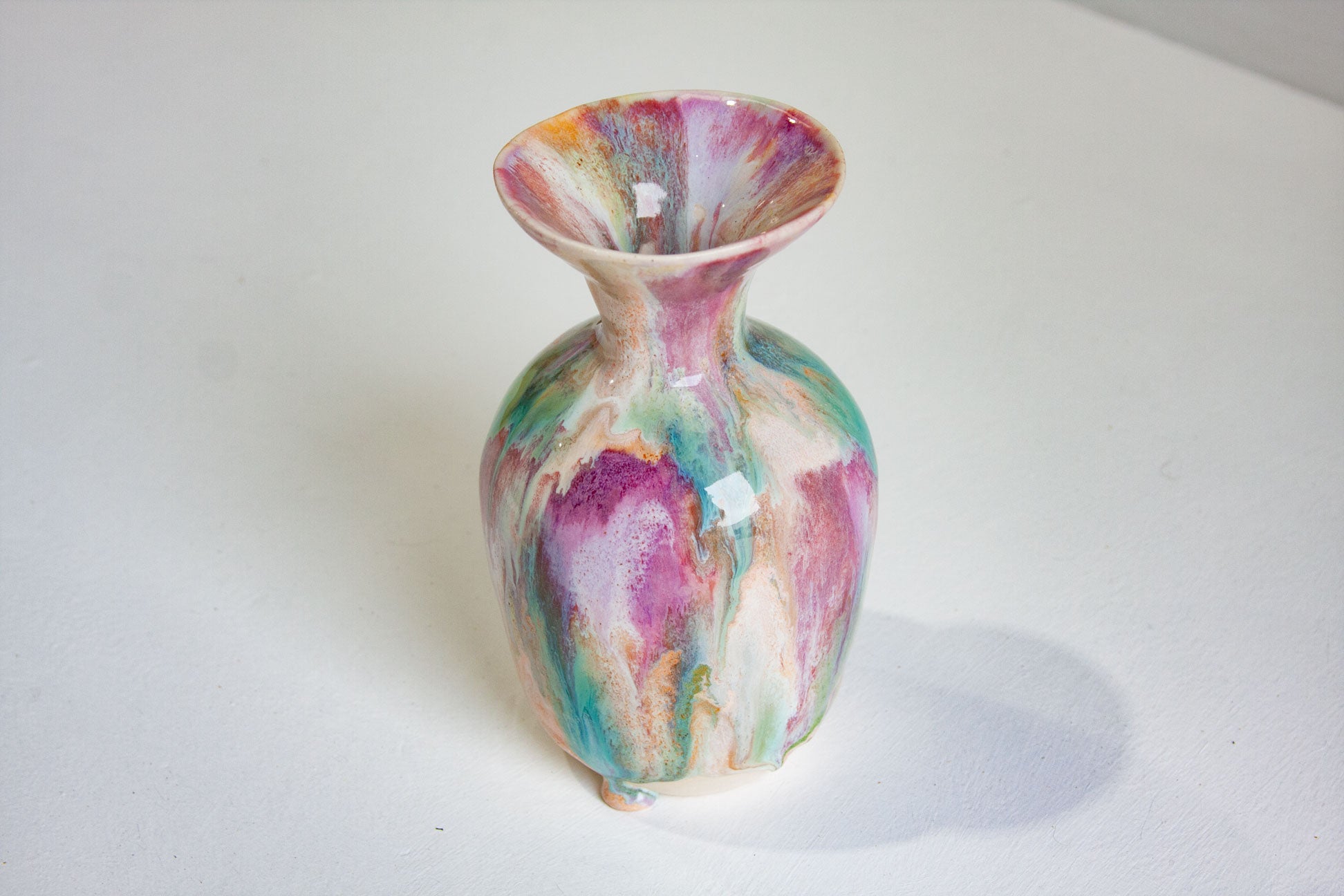 Multicolored ceramic vase on a white background