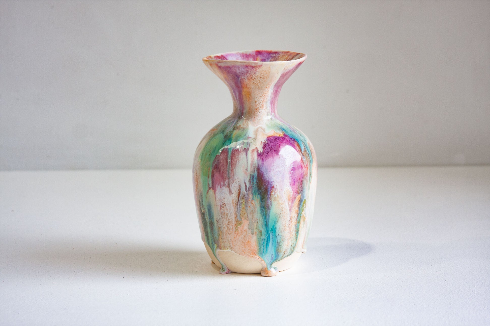 Multicolored ceramic vase on a white background