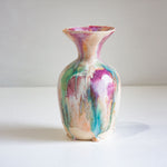 Multicolored ceramic vase on a white background