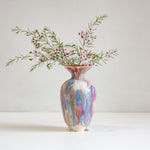 Multicolored vase with flowers on a white background
