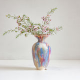 Multicolored vase with flowers on a white background